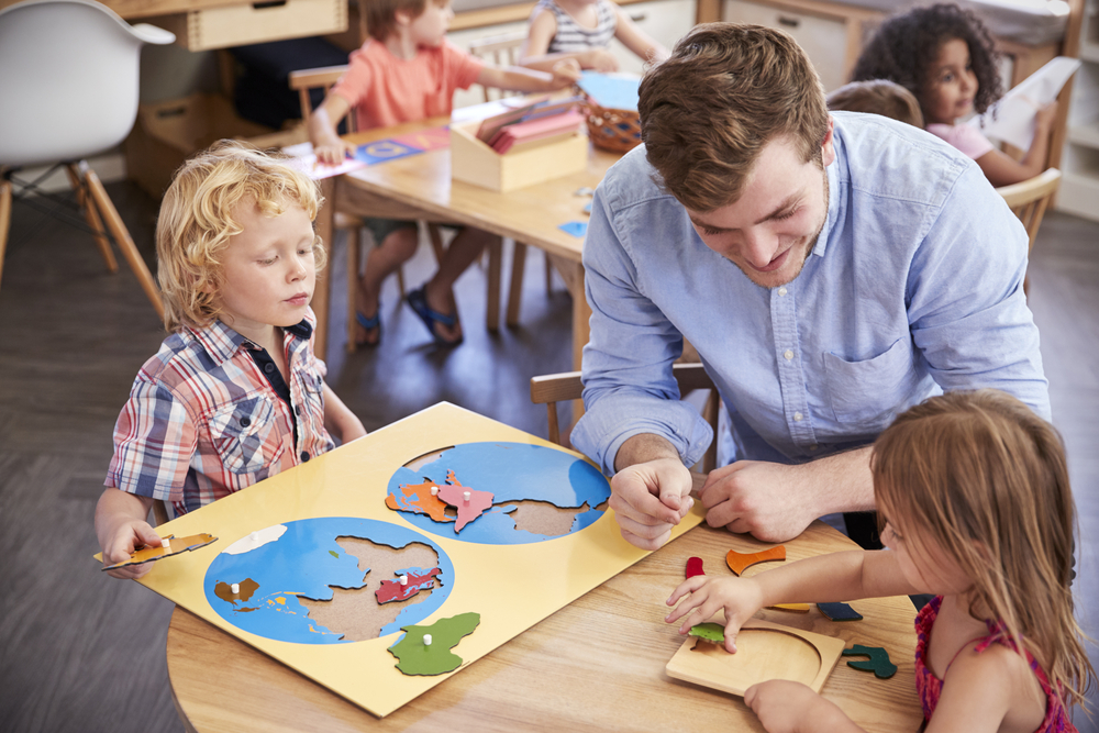 Teacher And Pupils Using Wooden Shapes In Montessori School Fishtown 